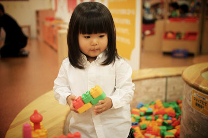 Young Asian girl playing with blocks