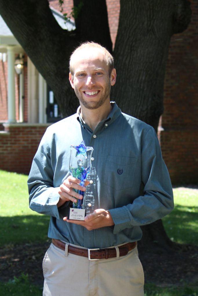 David Ayres holding award statue