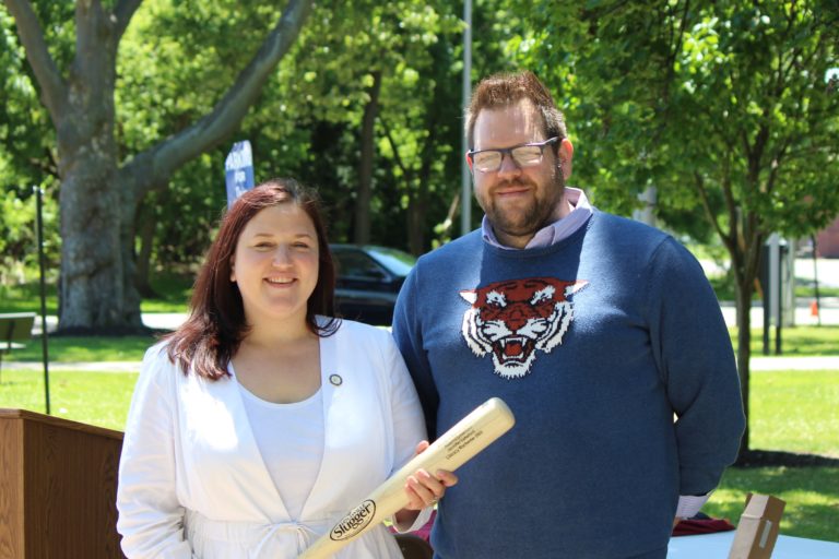 Assemblymember Jen Lunsford holding baseball bat with Joshua Stapf